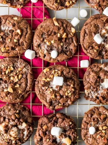 Overhead view of Rocky road cookies arranged in rows on a cooling rack.