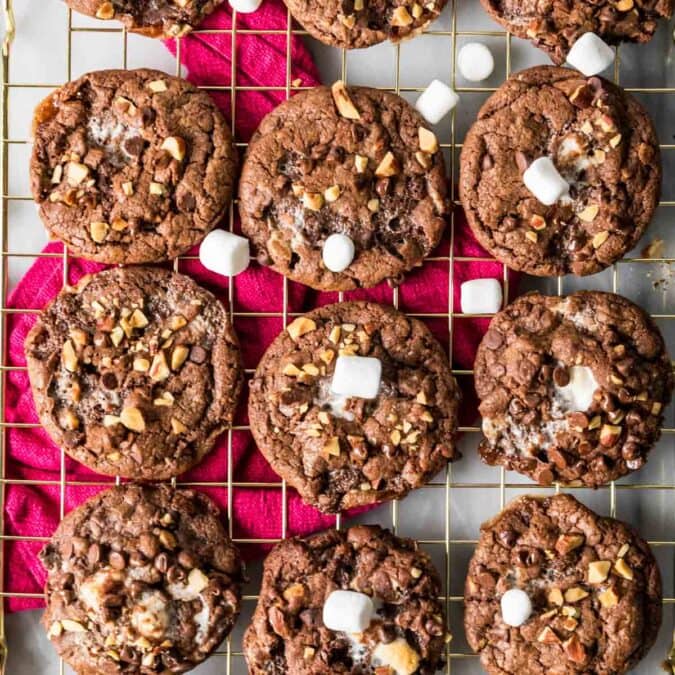 Overhead view of Rocky road cookies arranged in rows on a cooling rack.