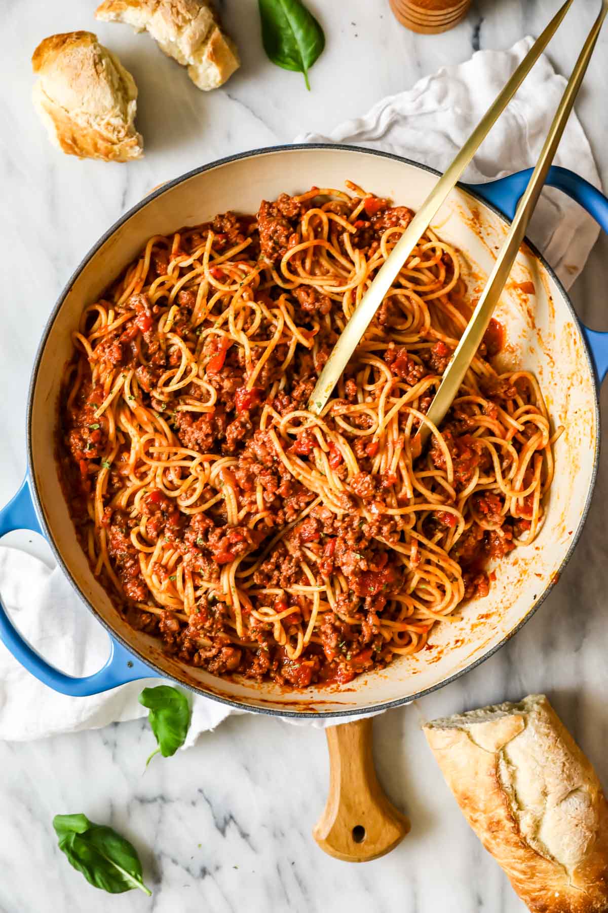 Overhead view of a large saucepan of spaghetti with meat sauce.