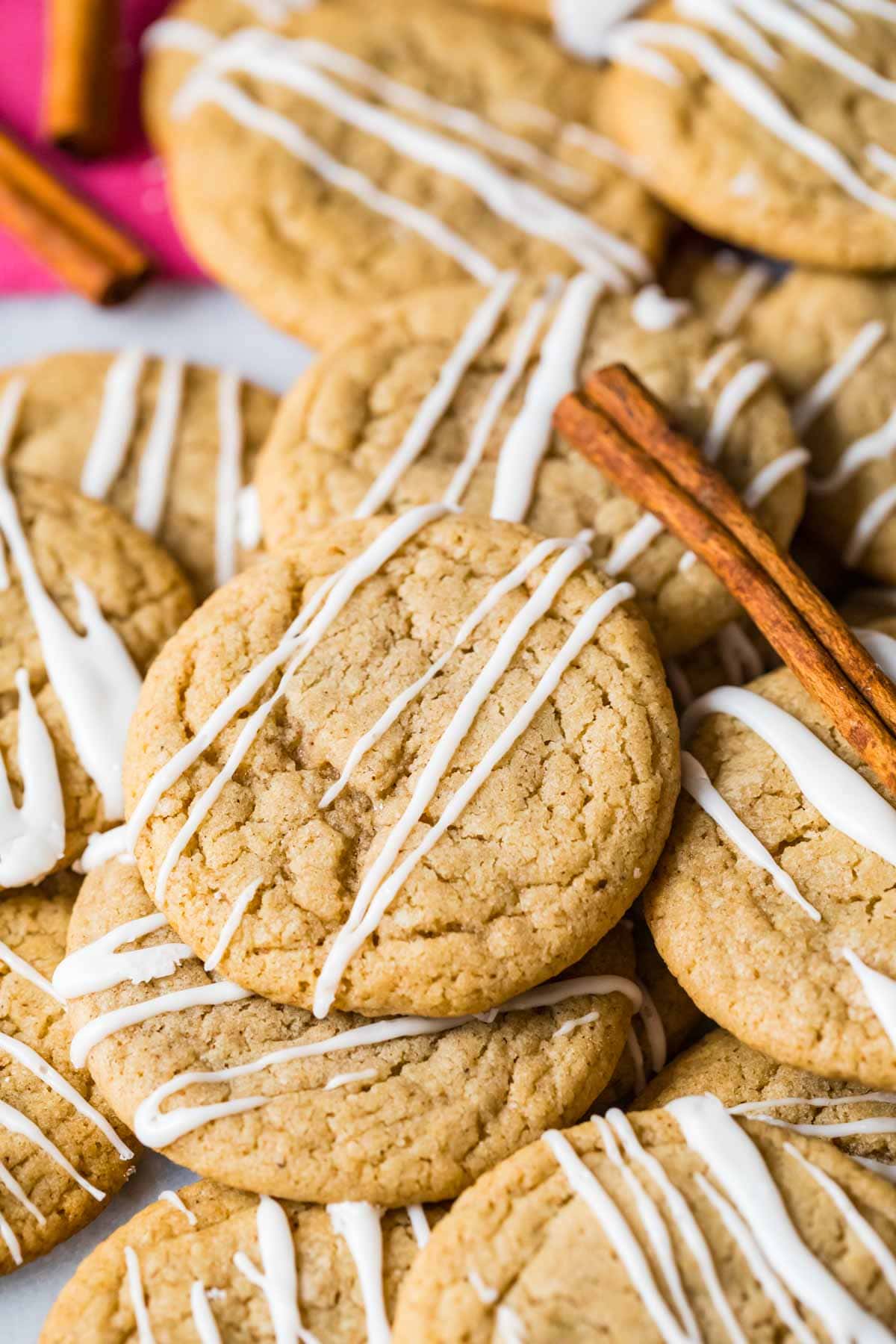 Pile of spice cookies topped with vanilla glaze.