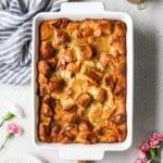 Overhead view of a bread pudding in a white casserole dish.