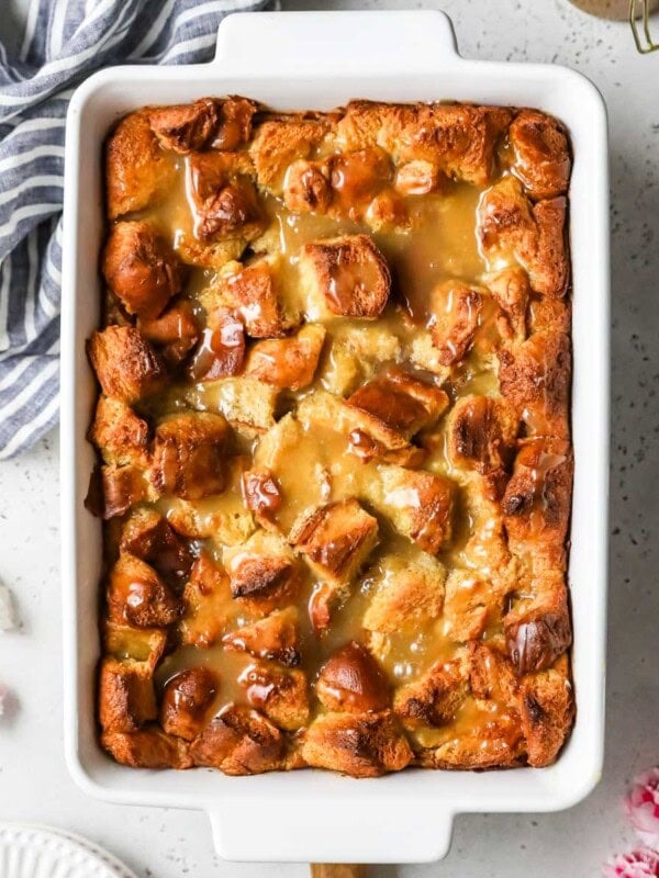 Overhead view of a bread pudding in a white casserole dish.