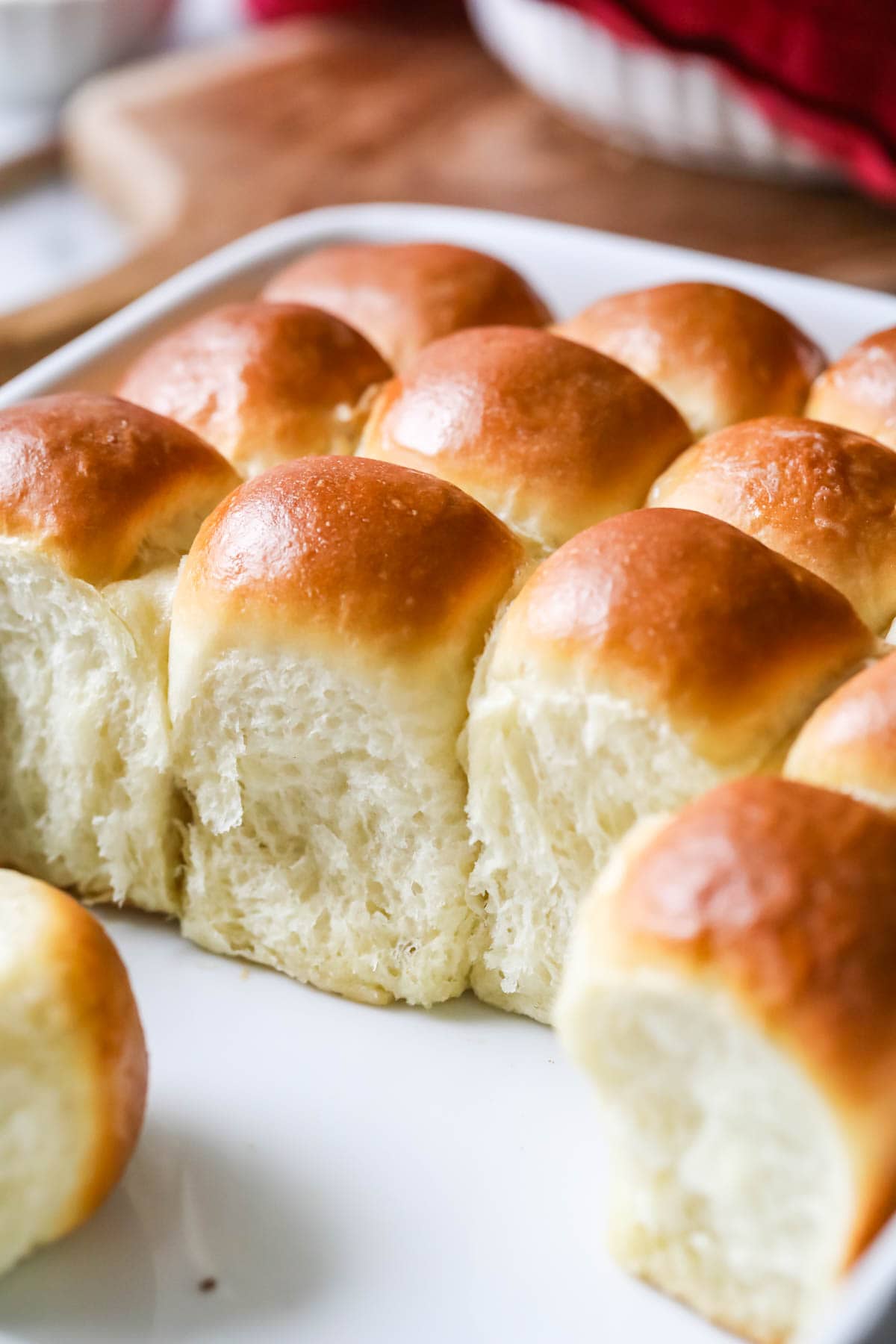Close up shot of tall, yeasted rolls with golden brown tops.