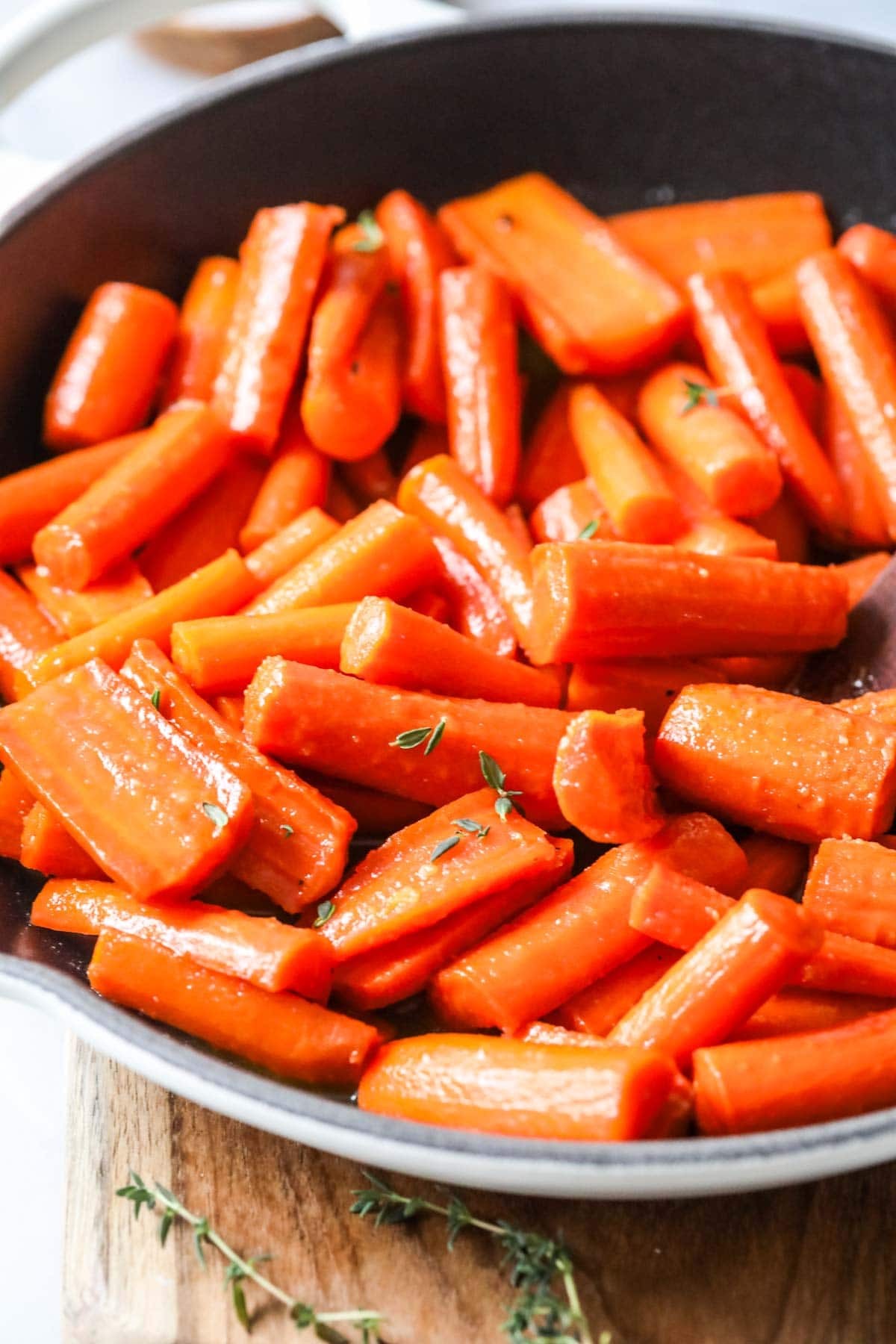 Close-up view of glazed carrots in a skillet.