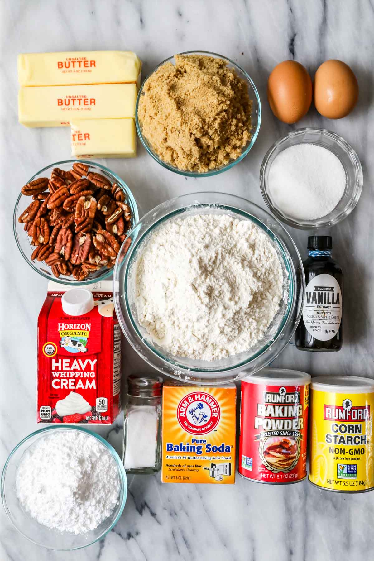 Overhead view of ingredients including pecans, brown sugar, eggs, and more. 