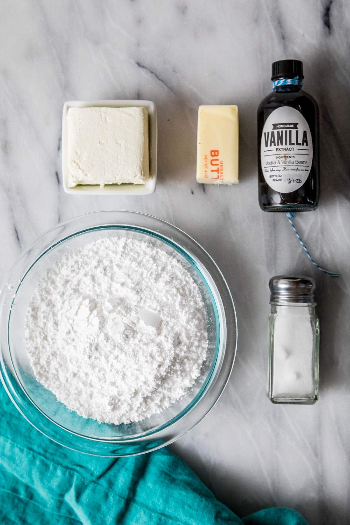 Overhead view of ingredients including cream cheese, butter, powdered sugar, and more.