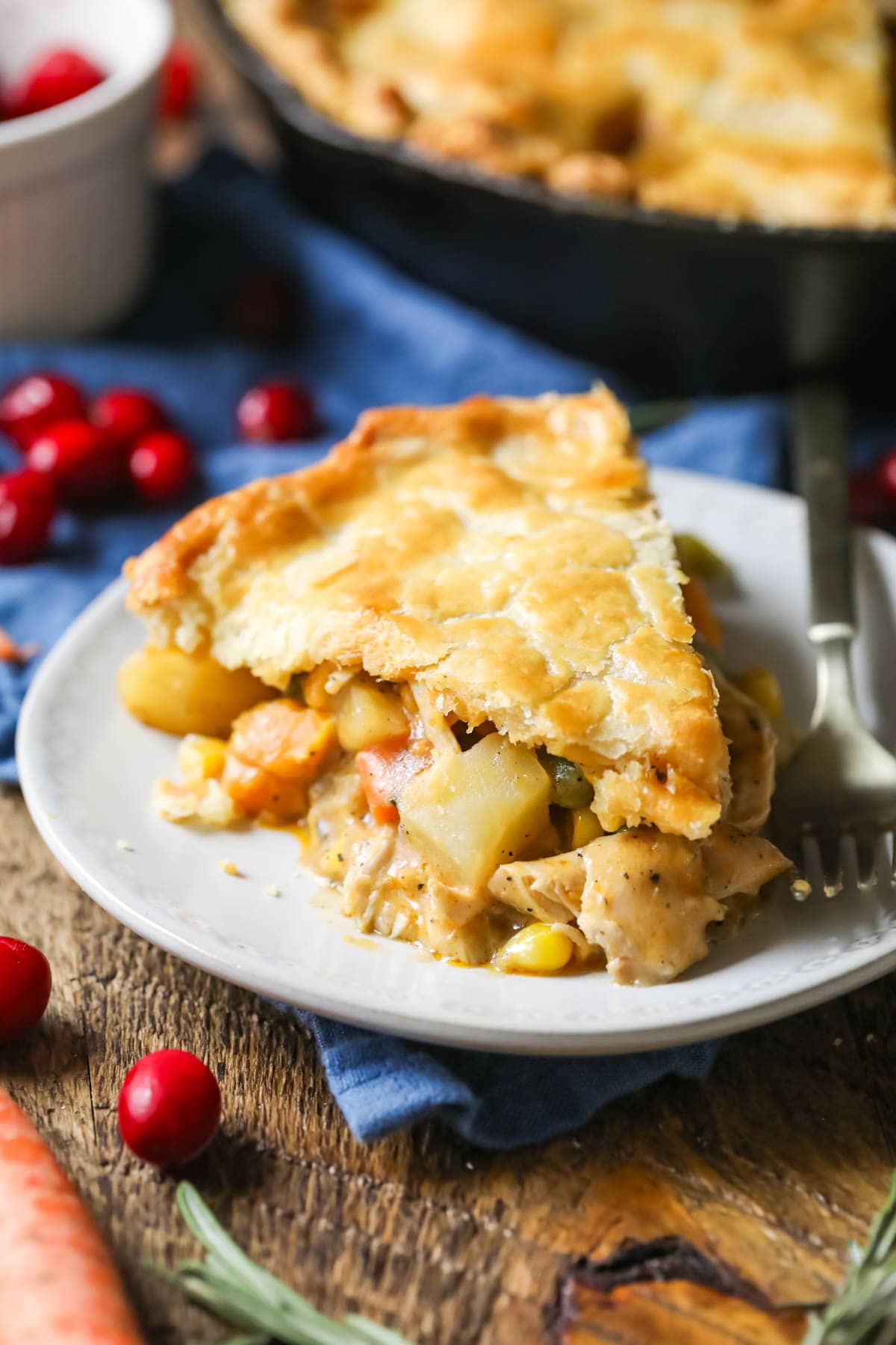 Slice of pot pie made with turkey and vegetables on a plate.