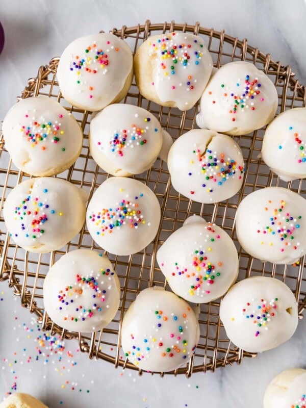 Overhead view of anise cookies on a round cooling rack.