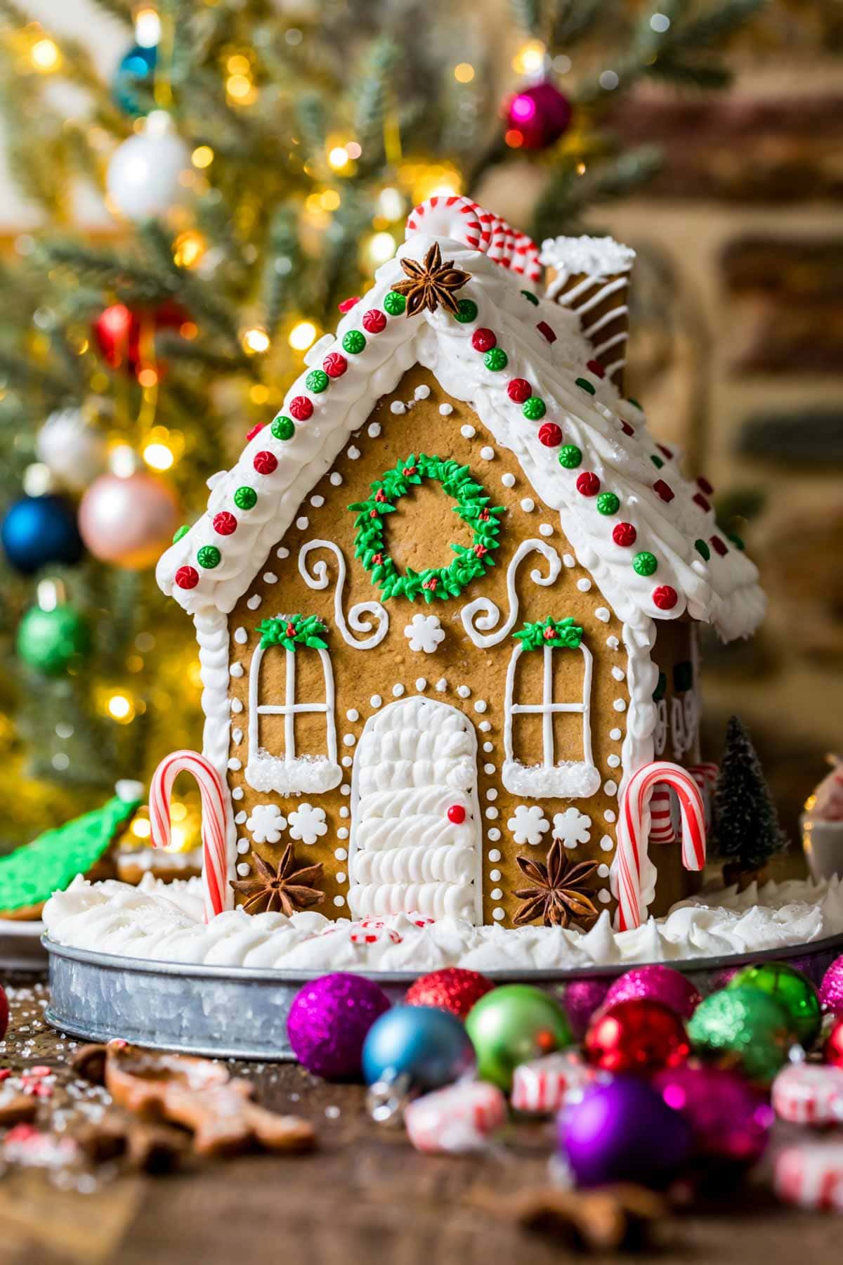 Festive gingerbread cookie house decorated with royal icing and candies.