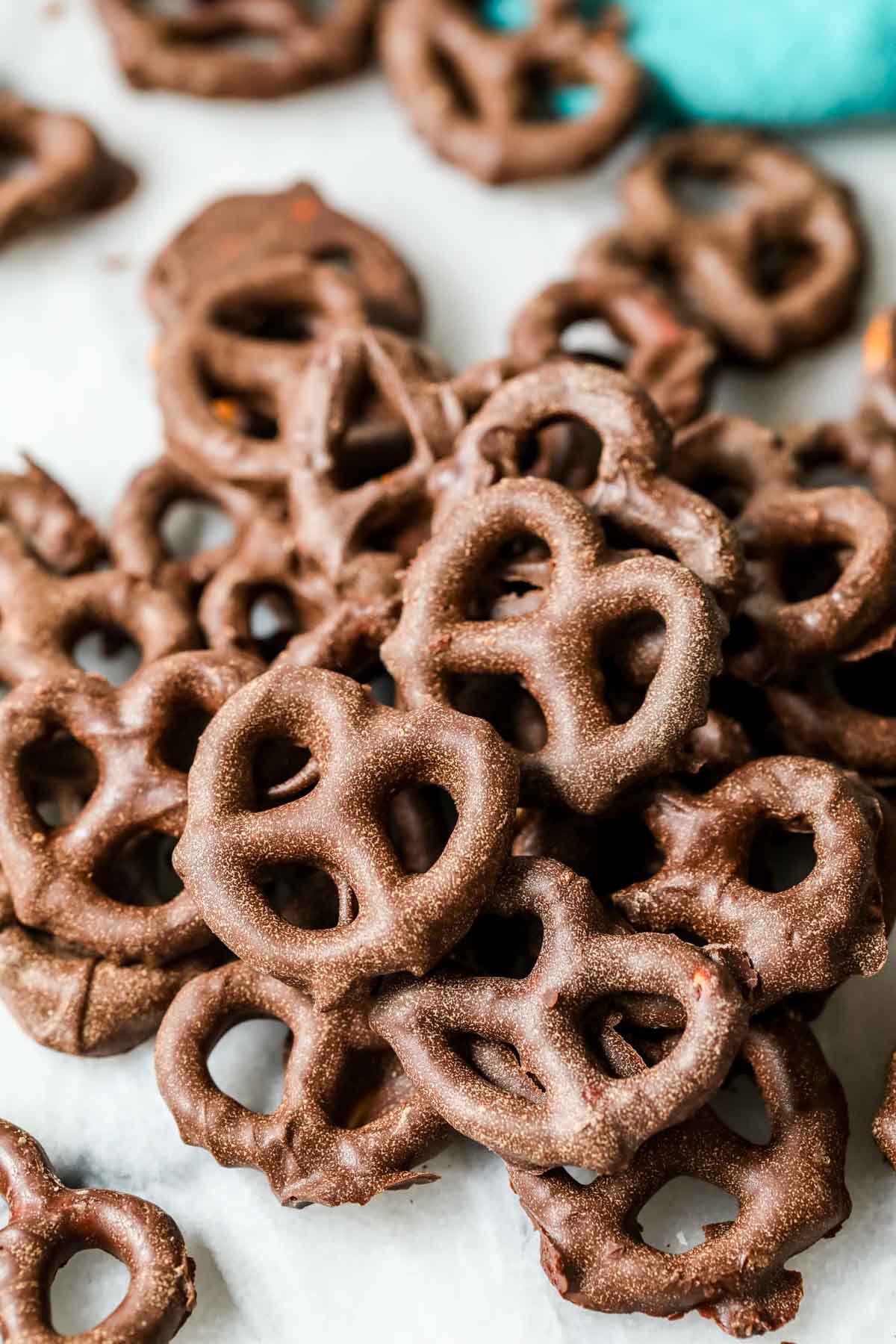 Close up view of chocolate dipped pretzels with a dull finish because the chocolate was not tempered.