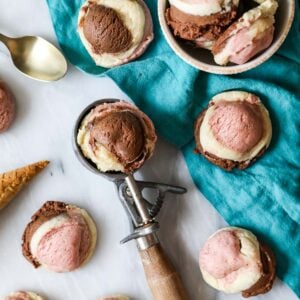 Neapolitan cookies scattered across a countertop with one cookie resting in an ice cream scoop.