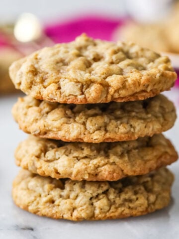 Stack of oatmeal cookies with pink cloth in background