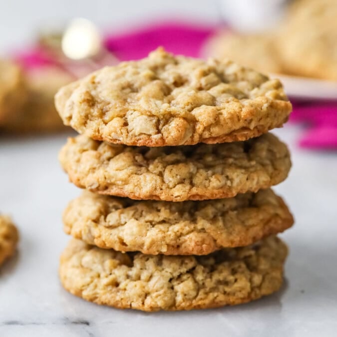 Stack of oatmeal cookies with pink cloth in background