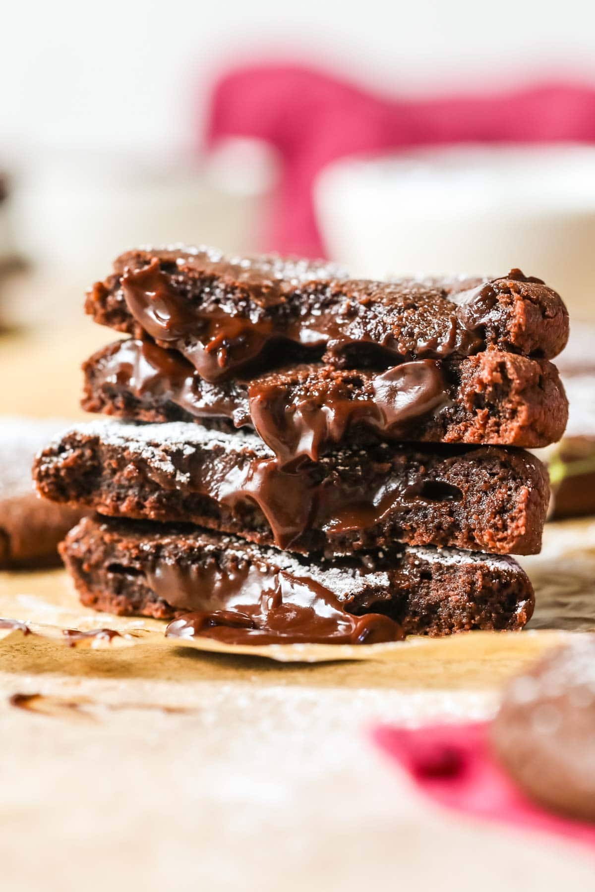 Stacked halves of chocolate cookies with molten ganache centers.