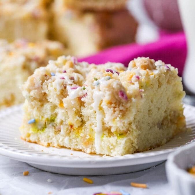 Slice of birthday crumb cake on a plate.