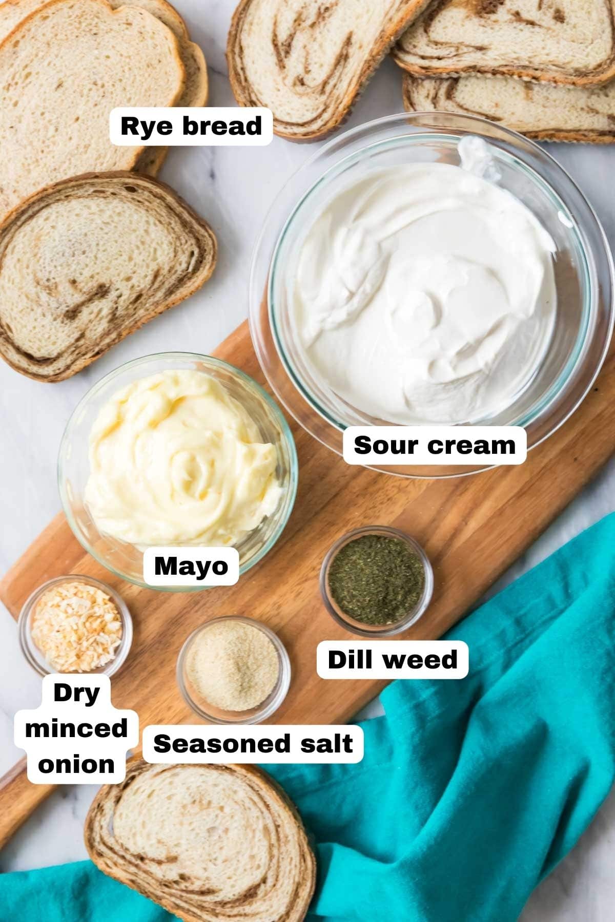 Overhead view of labelled ingredients including sour cream, mayo, dill, and more.