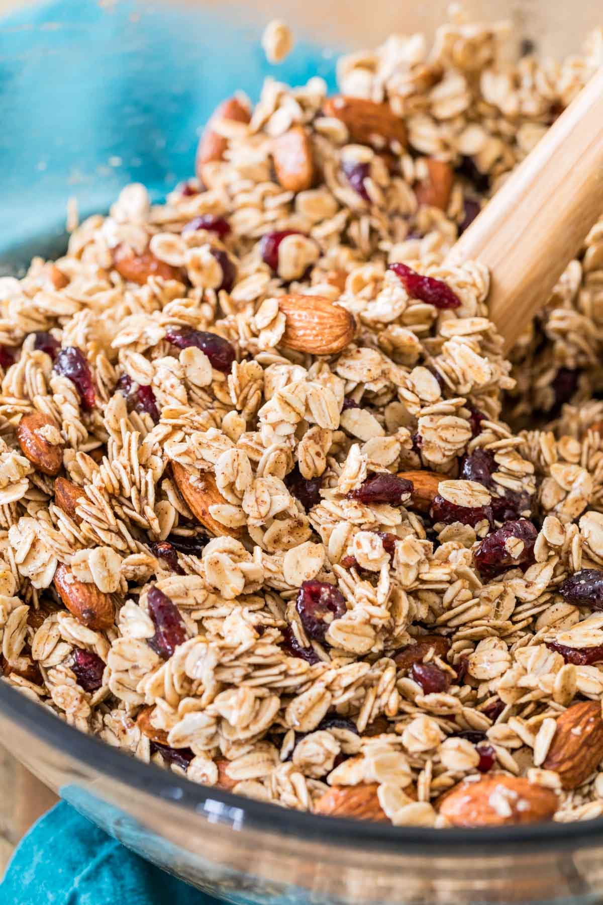 Making homemade granola in a glass bowl - mixing ingredients before baking
