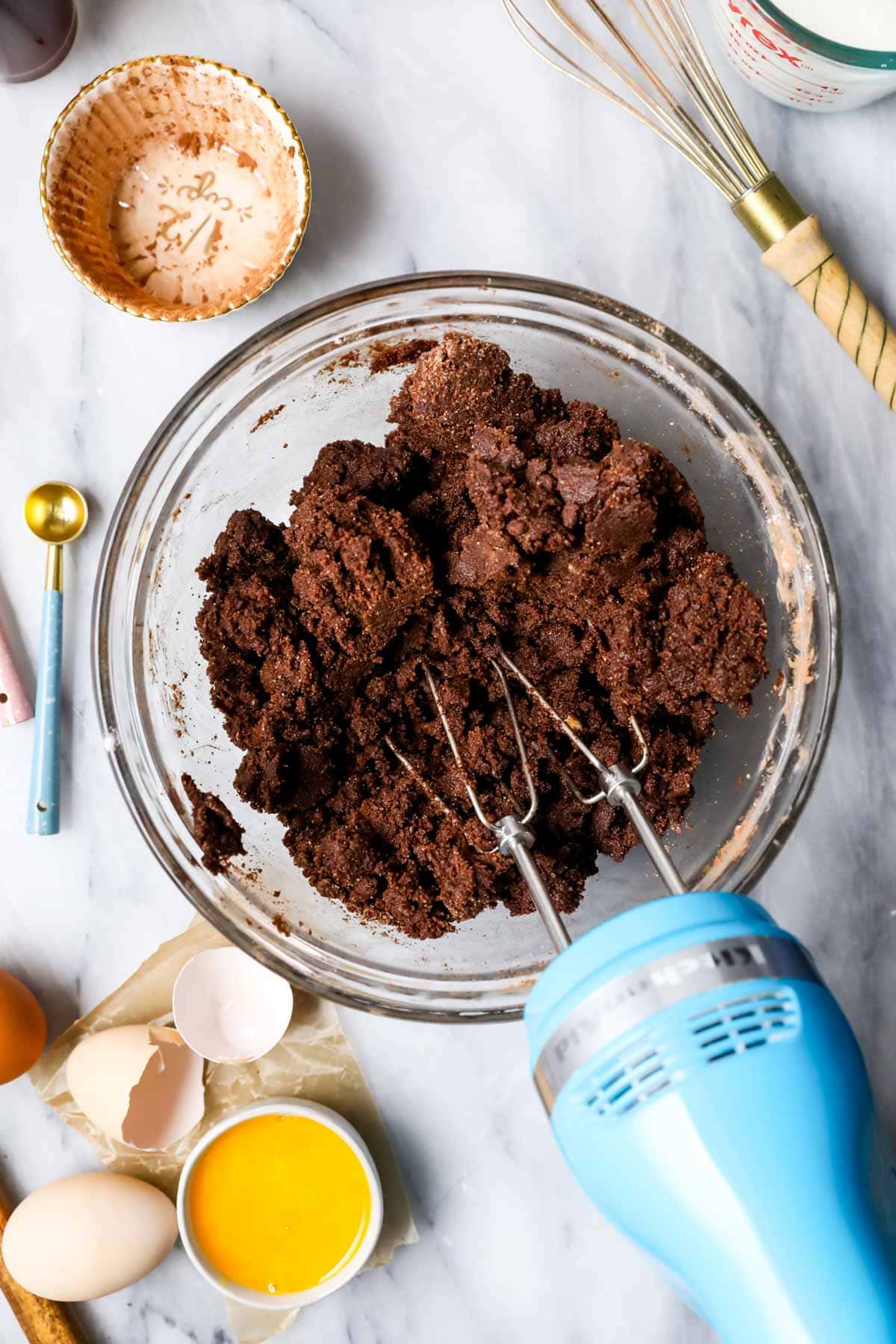 Overhead of chocolate cake batter, crumbly before the buttermilk and coffee are added.