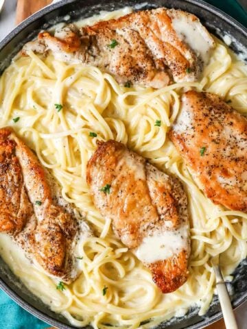 Overhead view of a skillet of chicken alfredo.