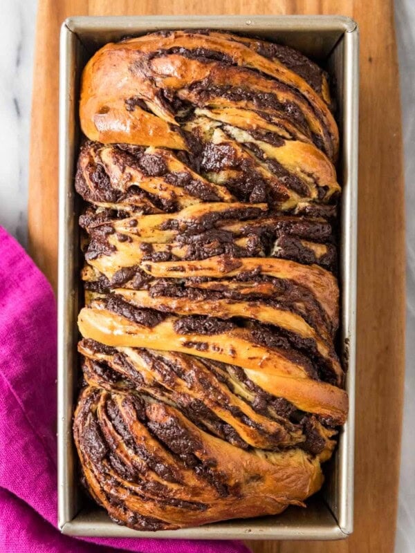 Overhead view of a loaf of chocolate babka in a pan.