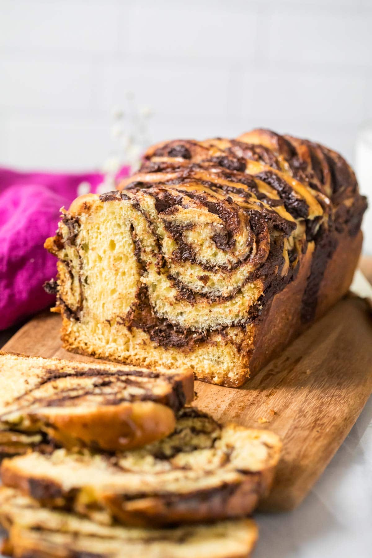 Loaf of chocolate babka that's been sliced to show the chocolate swirls.
