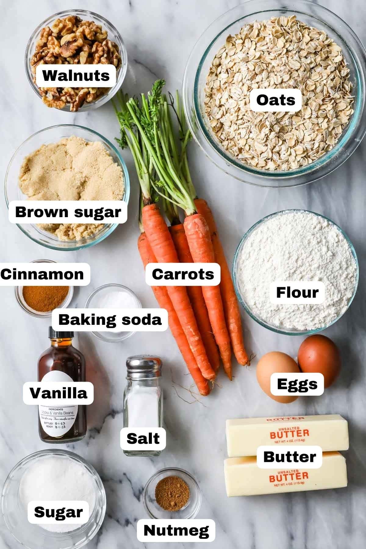 Overhead view of labeled ingredients including carrots, oats, walnuts, and more.