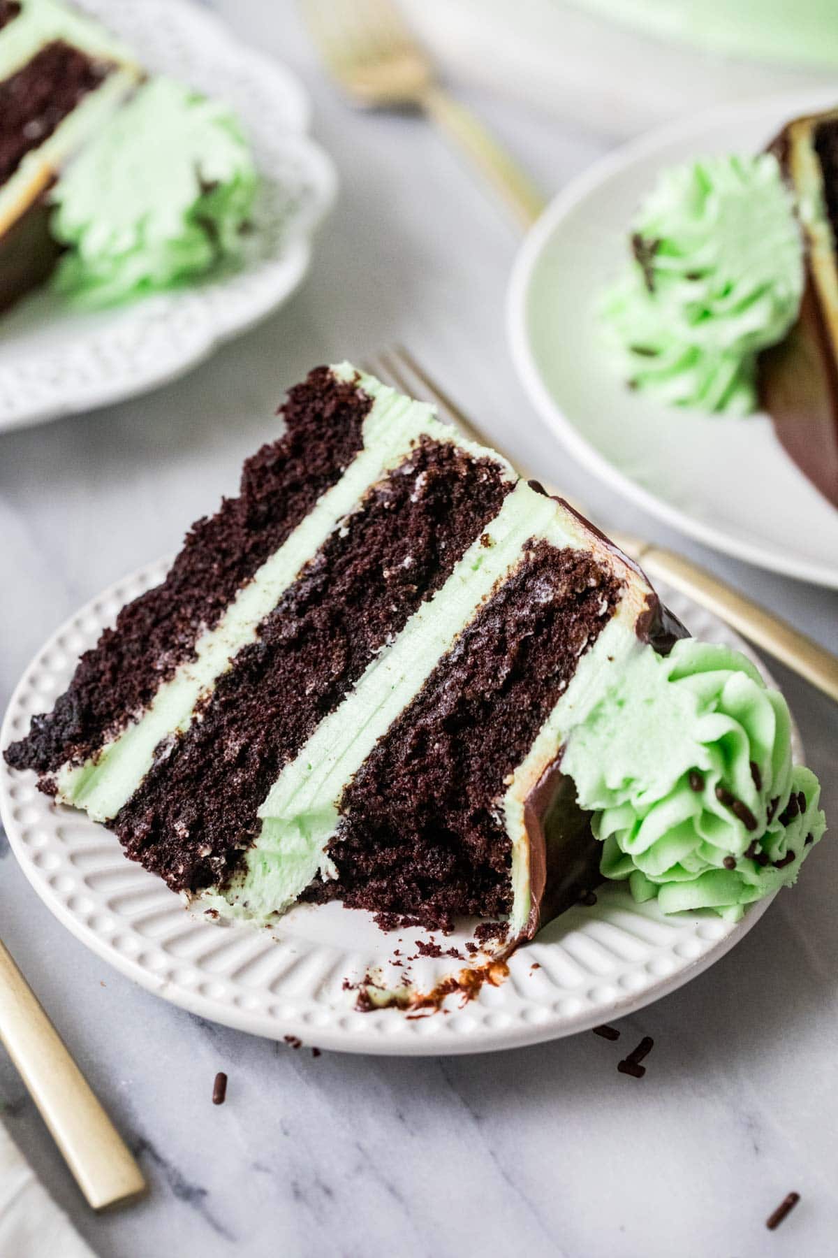 Slice of mint chocolate cake made with three layers of chocolate cake and a mint frosting.