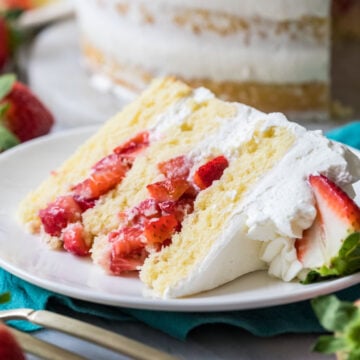 Slice of strawberry shortcake cake on a plate.
