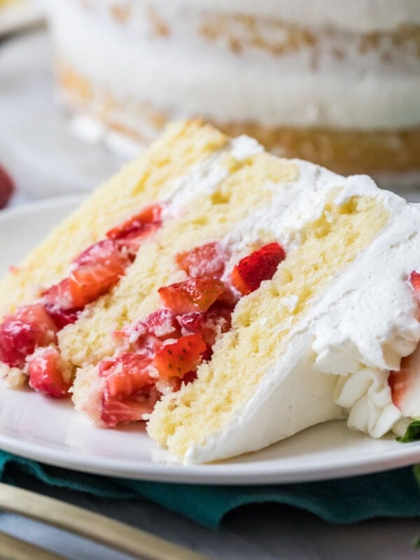 Slice of strawberry shortcake cake on a plate.