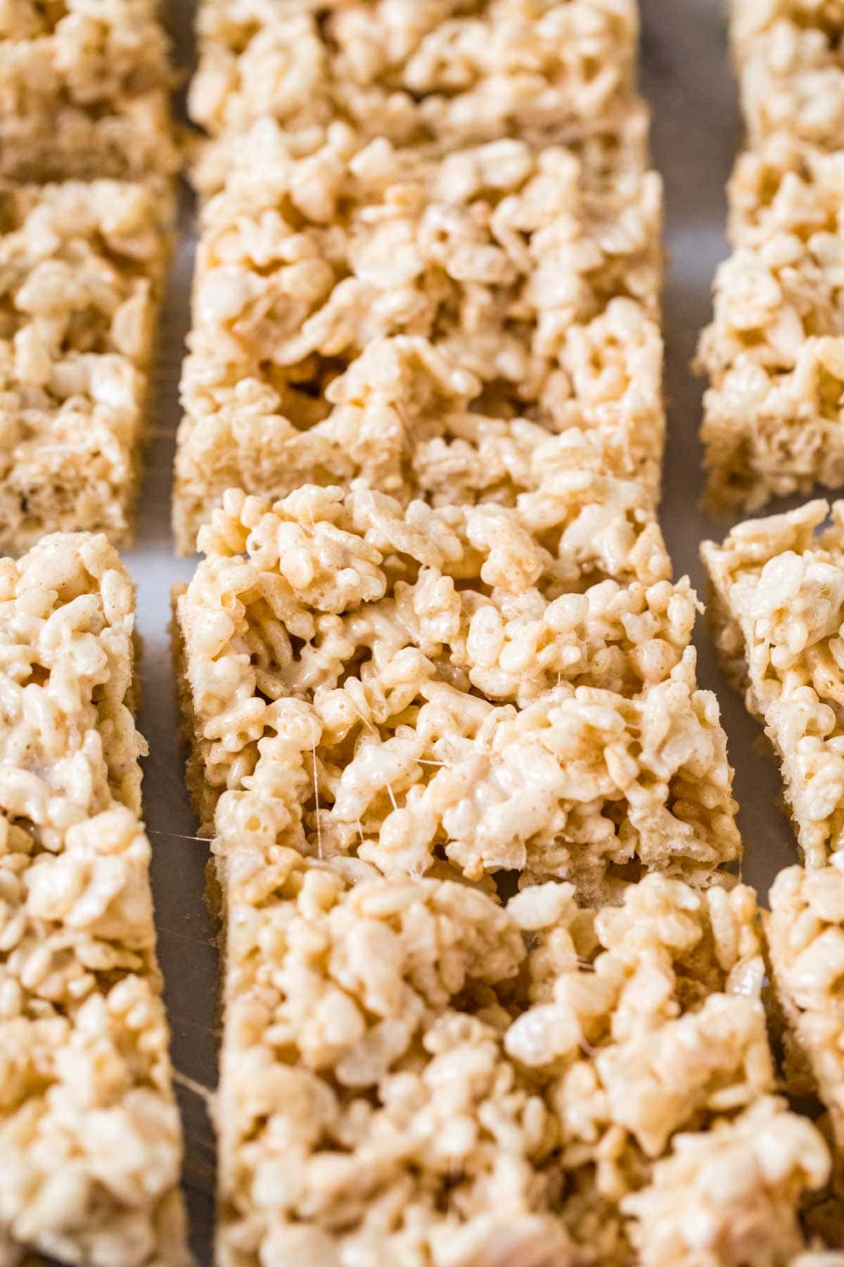 Close-up view of brown butter rice krispie treats arranged in neat rows.