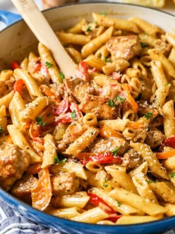 Creamy cajun chicken pasta in a blue saucepan.