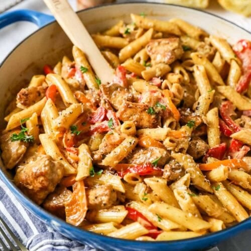 Creamy cajun chicken pasta in a blue saucepan.