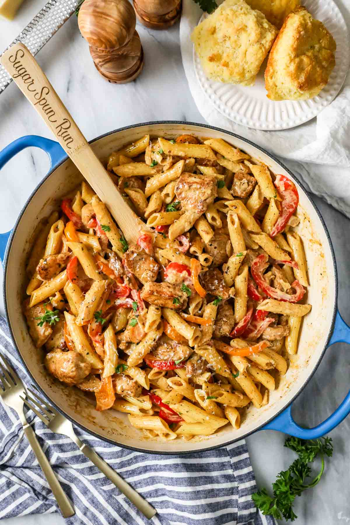 Overhead view of a pan with pasta, chicken, and veggies tossed in a creamy cajun sauce.