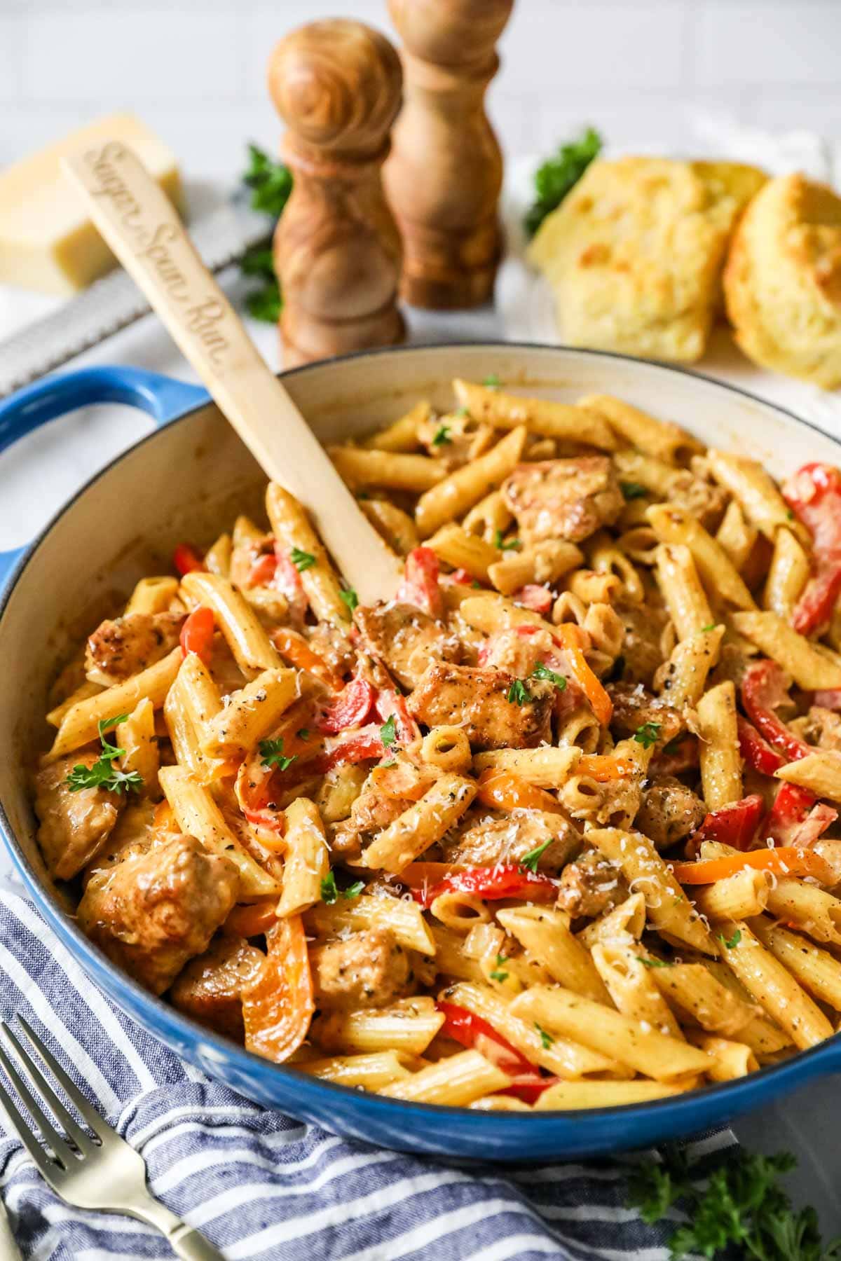 Creamy cajun chicken pasta in a blue saucepan.