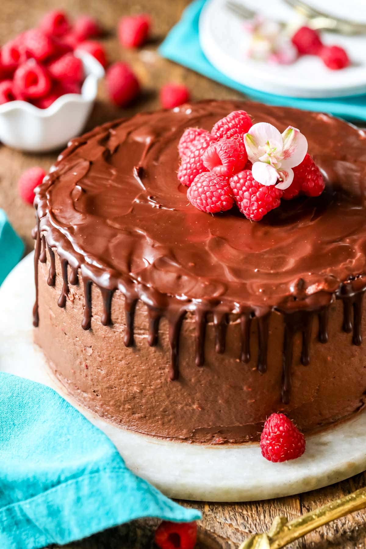 Chocolate raspberry cake with chocolate ganache and fresh raspberries on top.