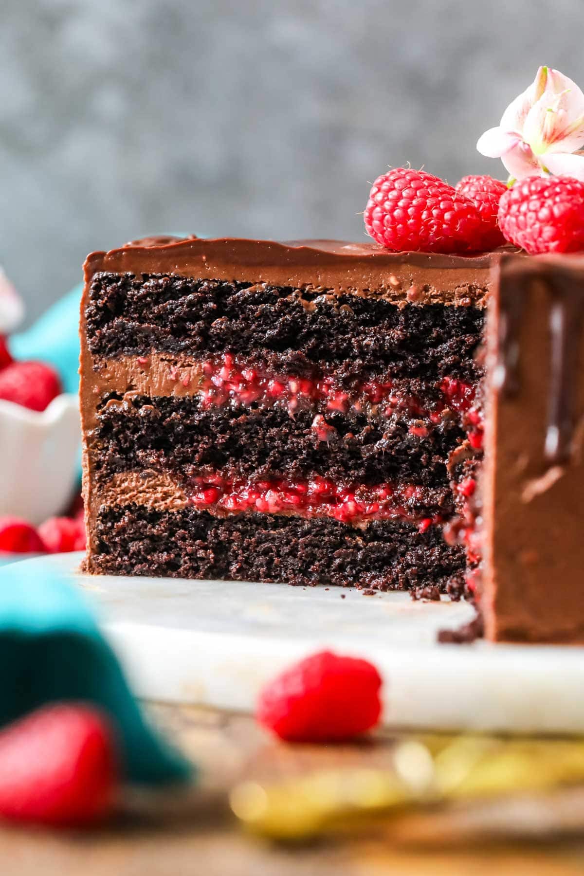 Cross section of a chocolate raspberry cake made with a raspberry filling and chocolate ganache topping.