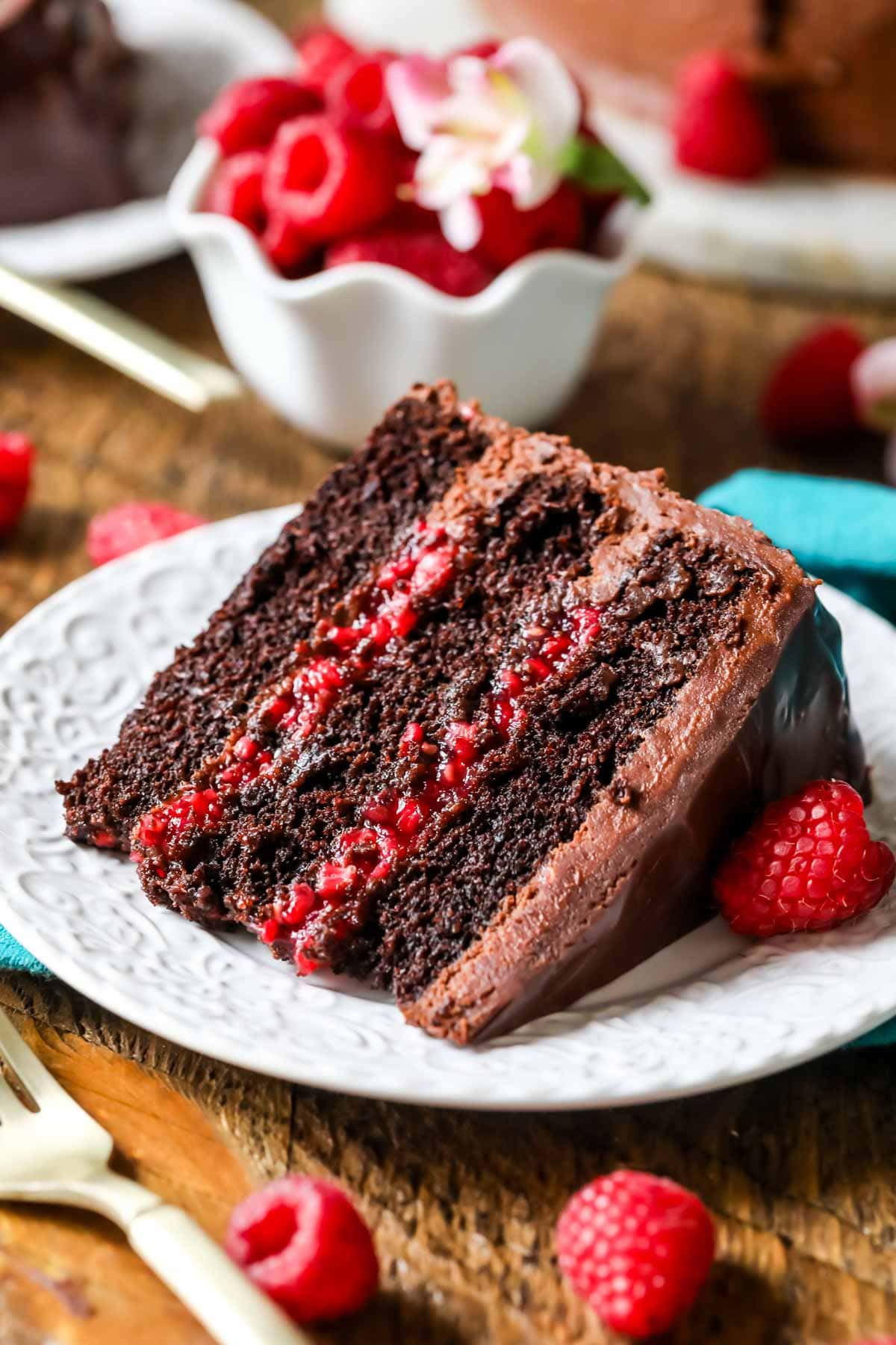 Slice of chocolate raspberry cake made with a raspberry filling and chocolate ganache topping.