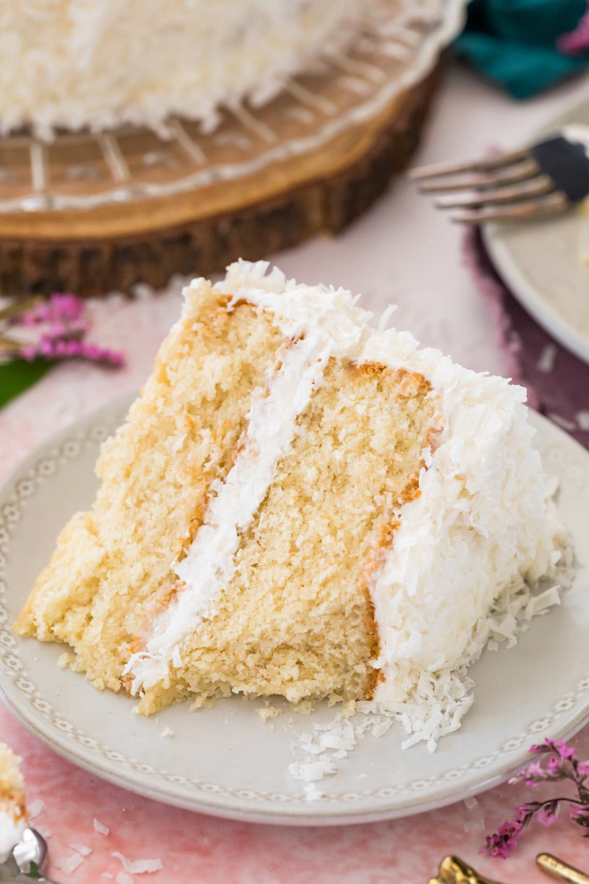 Slice of coconut cake on a white plate