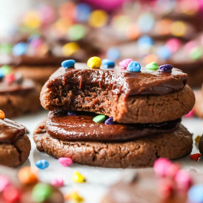 Two cosmic cookies stacked on top of each other with the top cookie missing a bite.