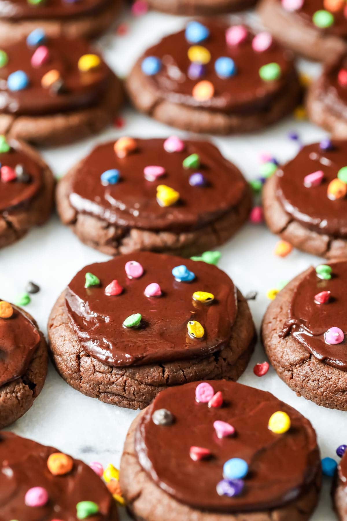 Chocolate cookies topped with fudge frosting and colored candy chips to look like cosmic brownies.