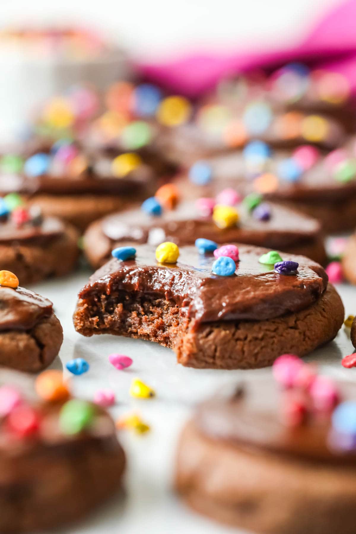 Chocolate cookies topped with fudge frosting and colored candy chips to look like cosmic brownies.