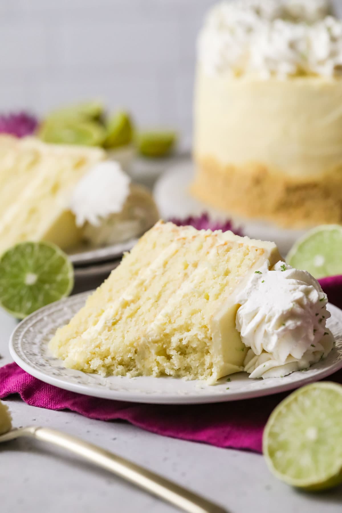 Slice of cake frosted with a key lime frosting missing a few bites.