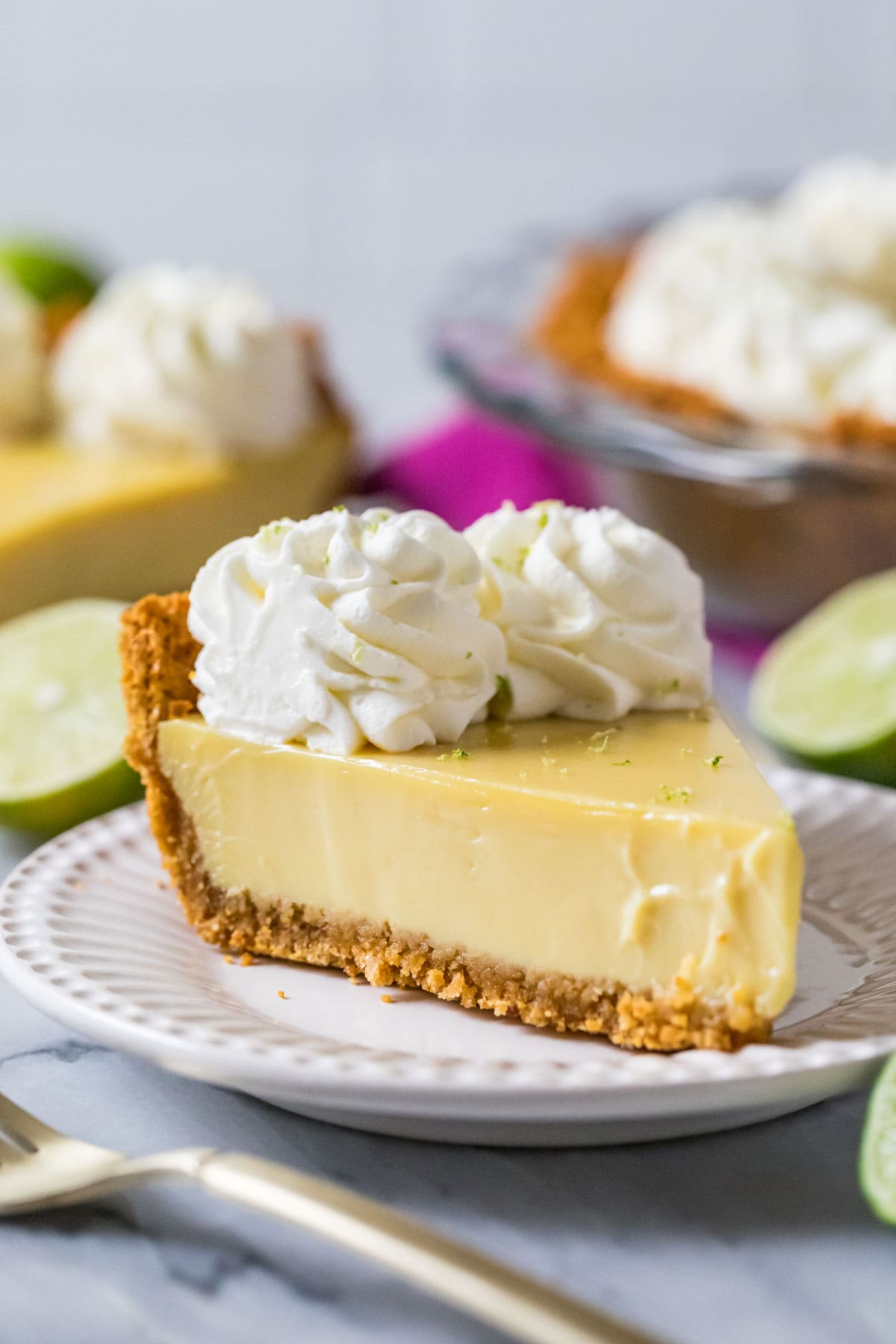 Slice of key lime pie on a white plate.