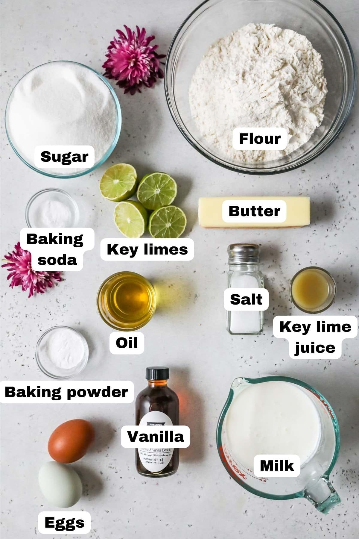 Overhead view of labelled cake ingredients including key limes, buttermilk, eggs, and more.