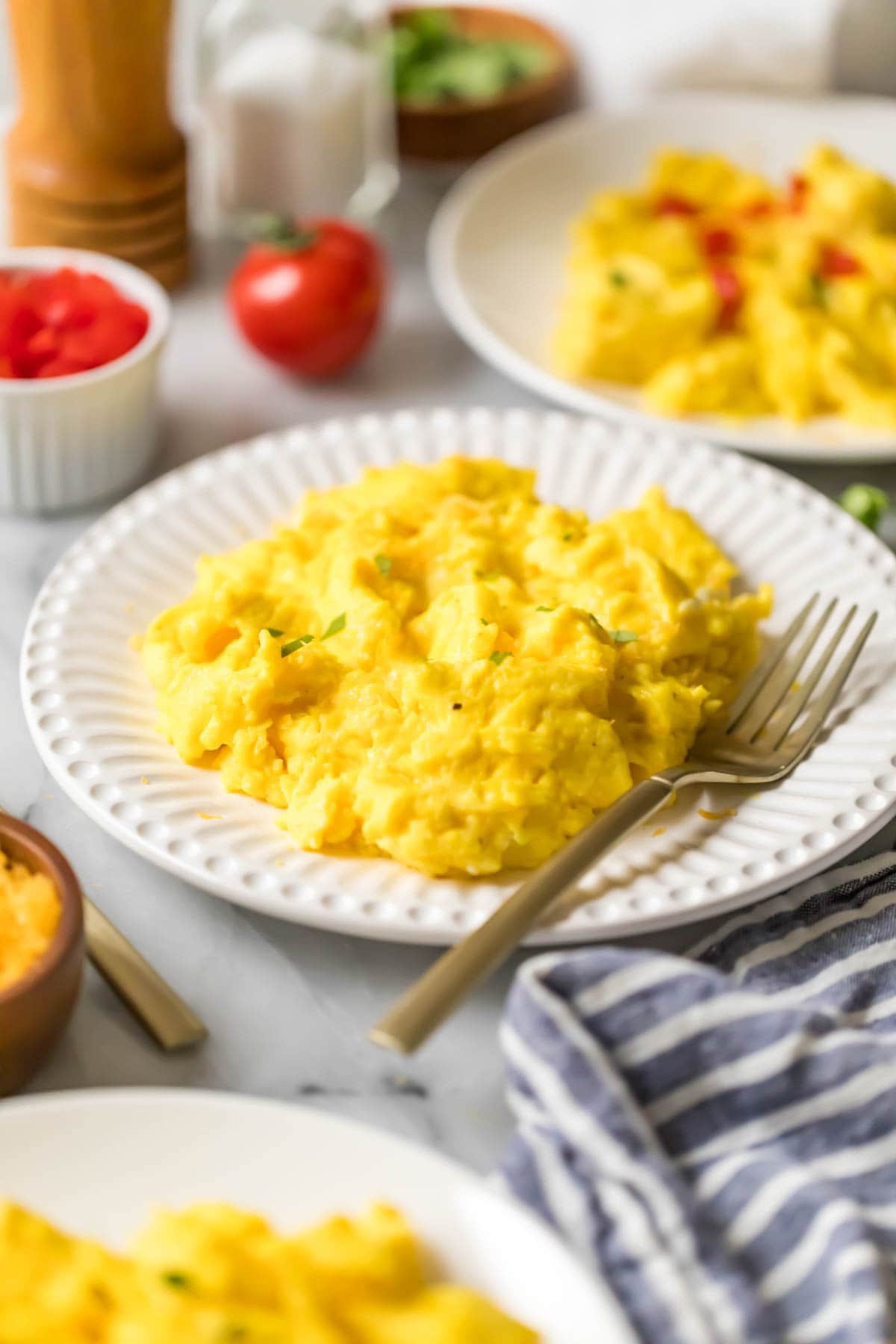 Plate of eggs that have been scrambled.