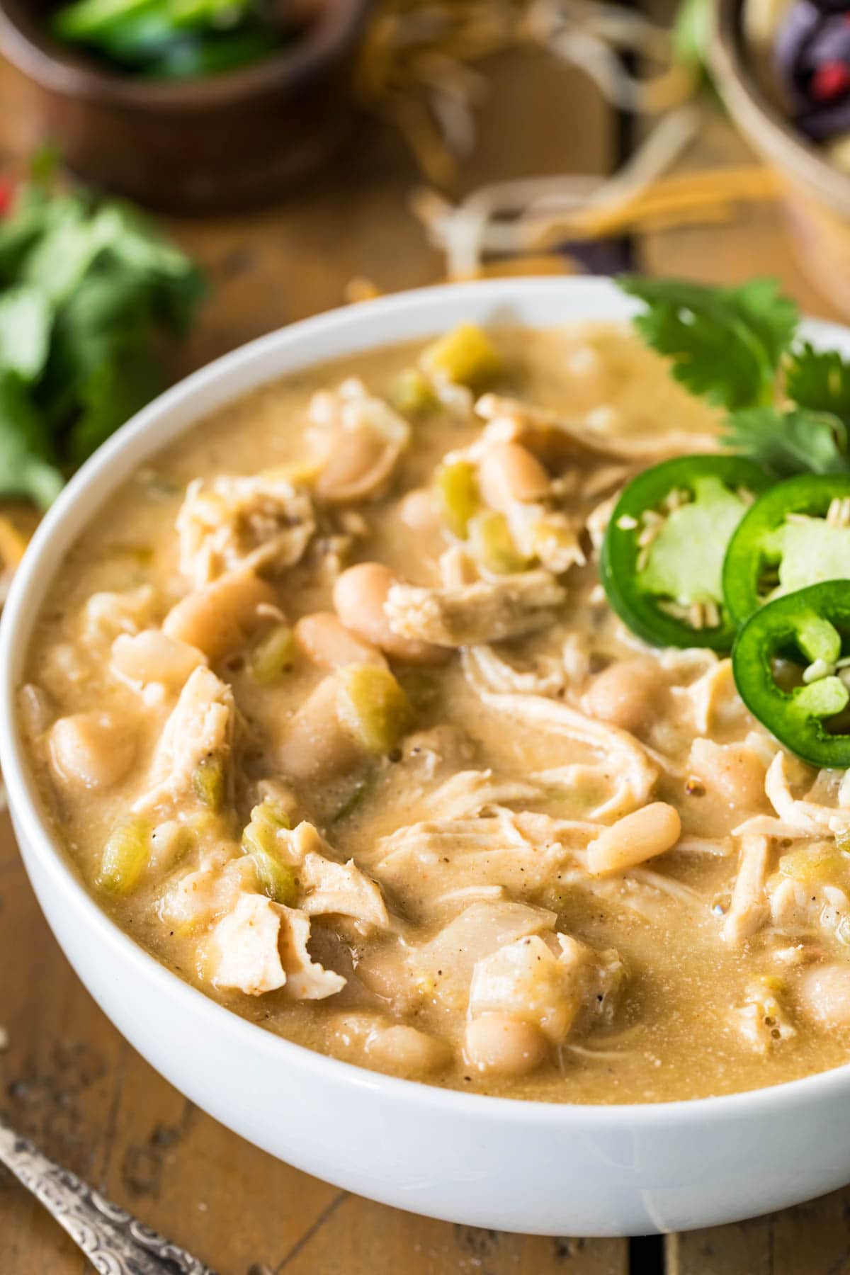 Close-up view of a bowl of white chicken chili topped with cilantro.