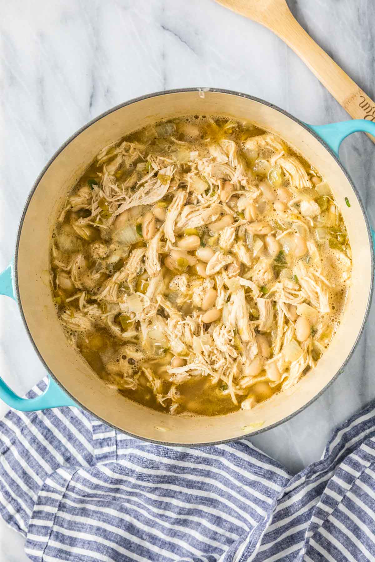 Overhead view of a pot of white chili made with chicken and white beans.