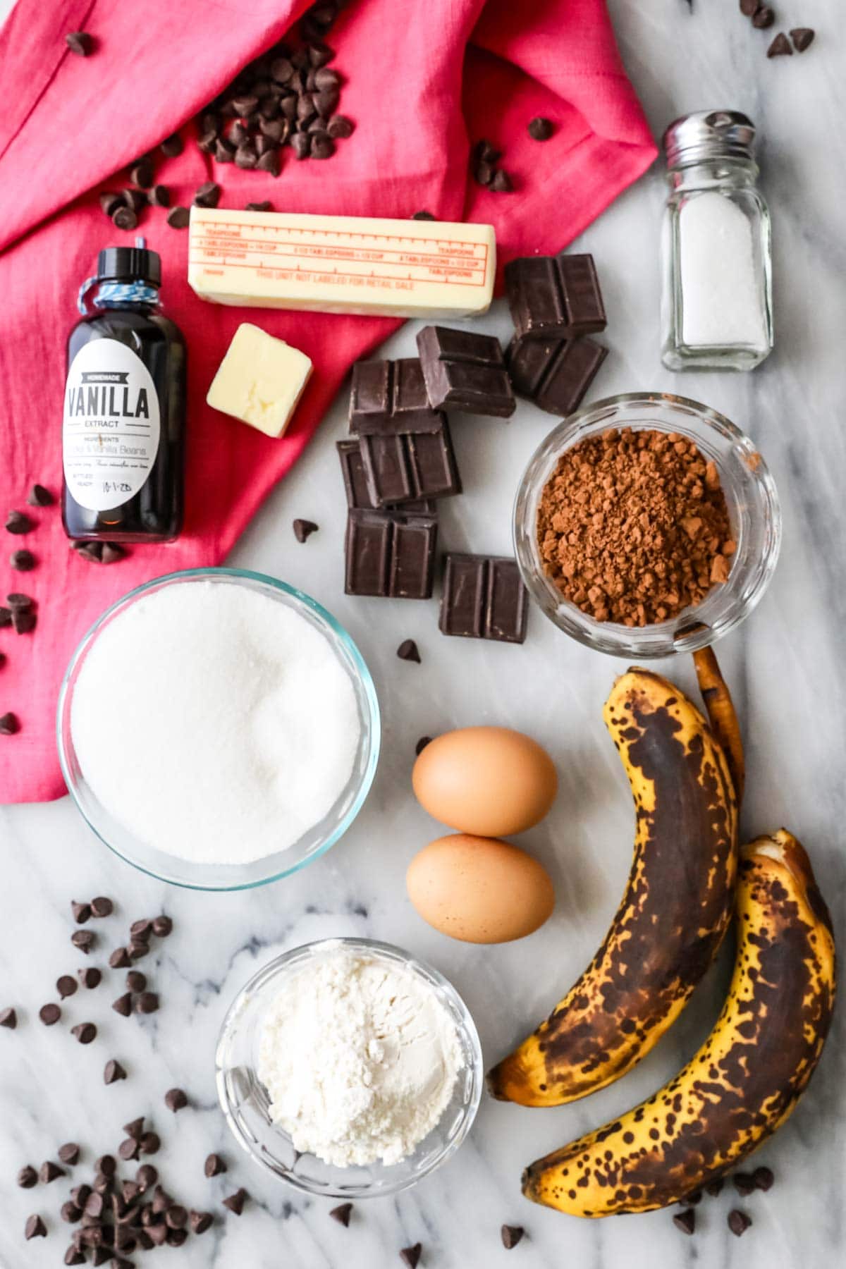 Overhead view of ingredients including bananas, chocolate, cocoa powder, and more.