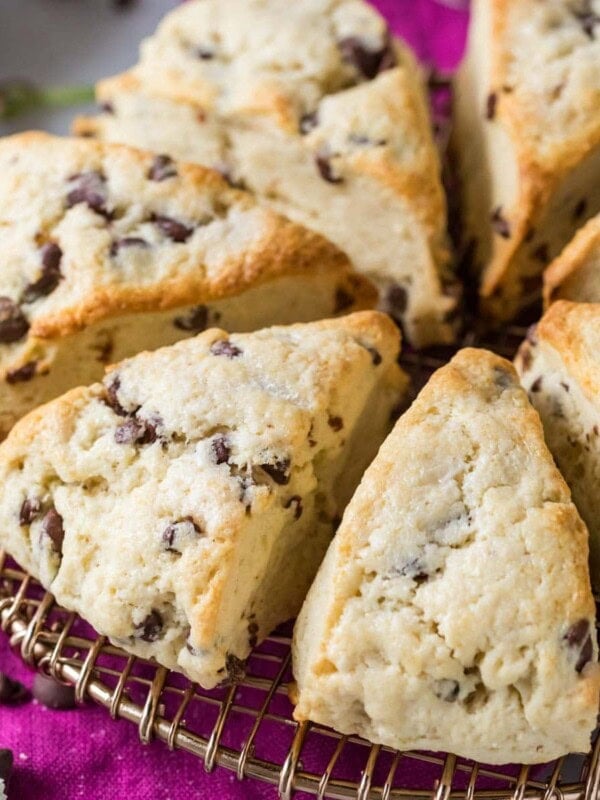 Chocolate chip sourdough scones arranged in a circle on a round cooling rack.