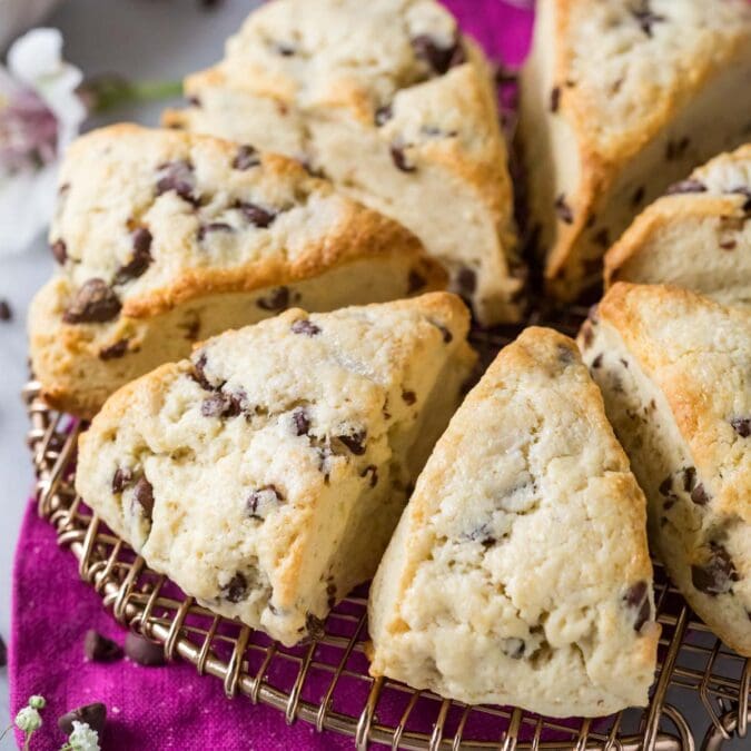 Chocolate chip sourdough scones arranged in a circle on a round cooling rack.